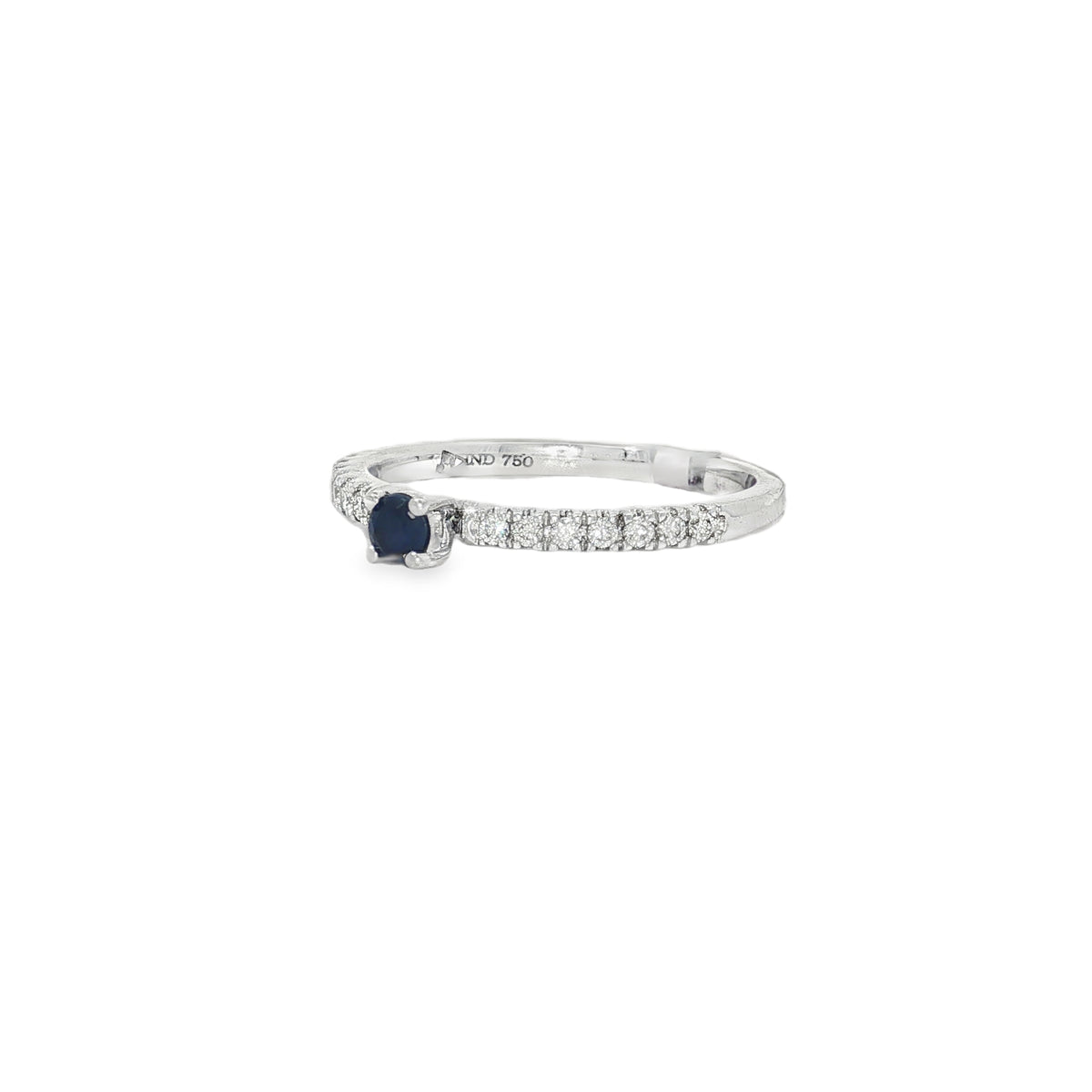 Angled view of white gold diamond band ring showing raised blue centre sapphire