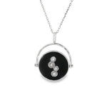 White gold necklace with black disc, circular frame and four diamond clusters