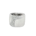 Angled view of wide white gold ring and diagonal pavé setting