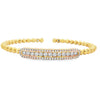 Yellow gold beaded bangle with elongated round diamond station