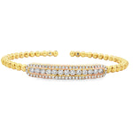 Yellow gold beaded bangle with elongated round diamond station