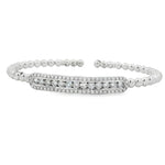 White gold beaded bangle with elongated round diamond station