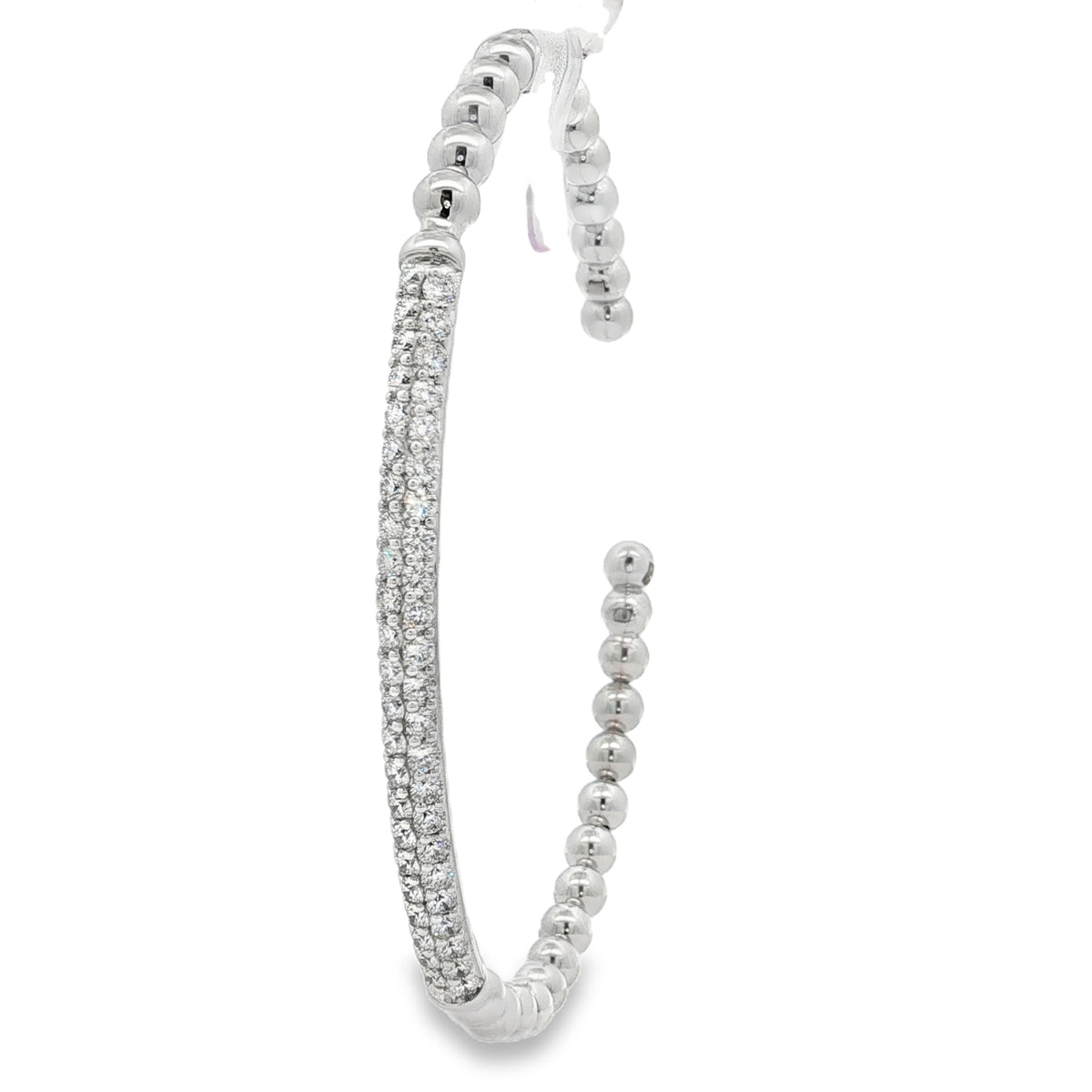 Angled view of beaded open bangle and pavé diamond centerpiece