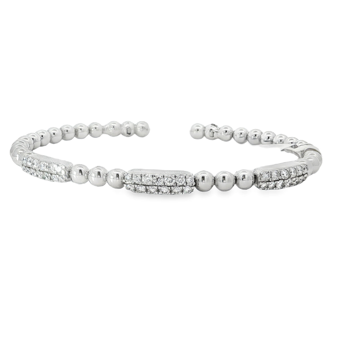White gold open bangle with three round diamond stations
