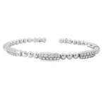 White gold open bangle with three round diamond stations