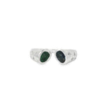 White gold open ring with oval emerald and sapphire ends and scattered diamonds