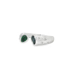 Angled view of sapphire and emerald oval duo ring showing broad diamond-dotted shoulders