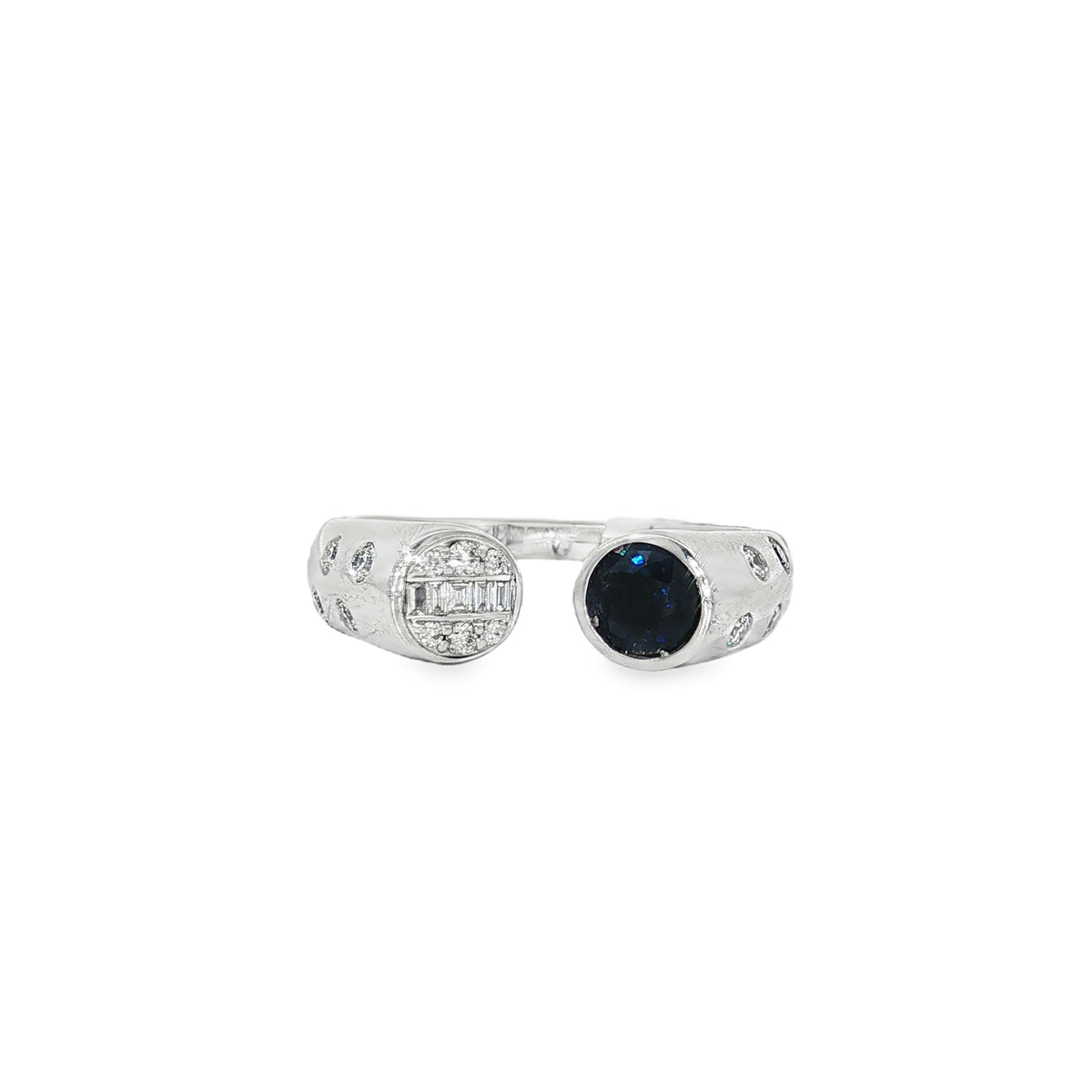 White gold open ring with round sapphire opposite a baguette and round diamond medallion