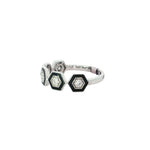 Angled view of repeating hexagonal diamond motifs on white gold band