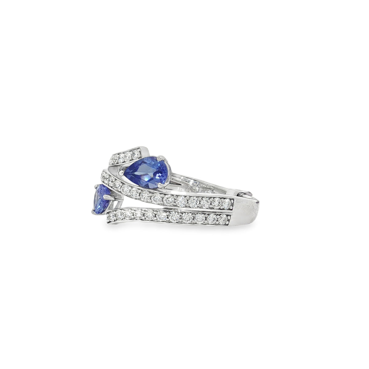Angled view showing twin pear tanzanites between diamond crossover bands