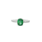 White gold ring with oval emerald and round diamond shoulders