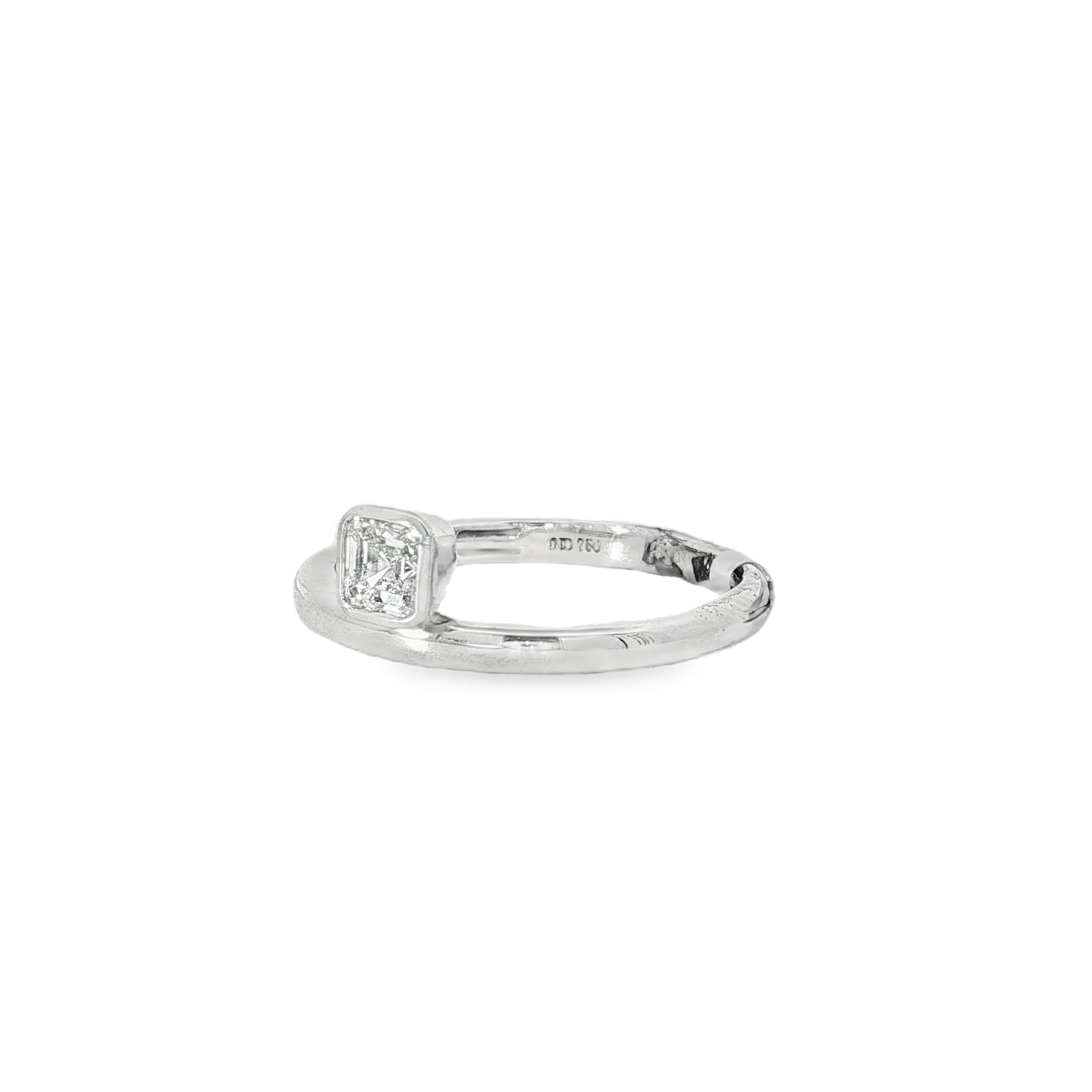 Angled view showing raised square cluster on slender white gold band