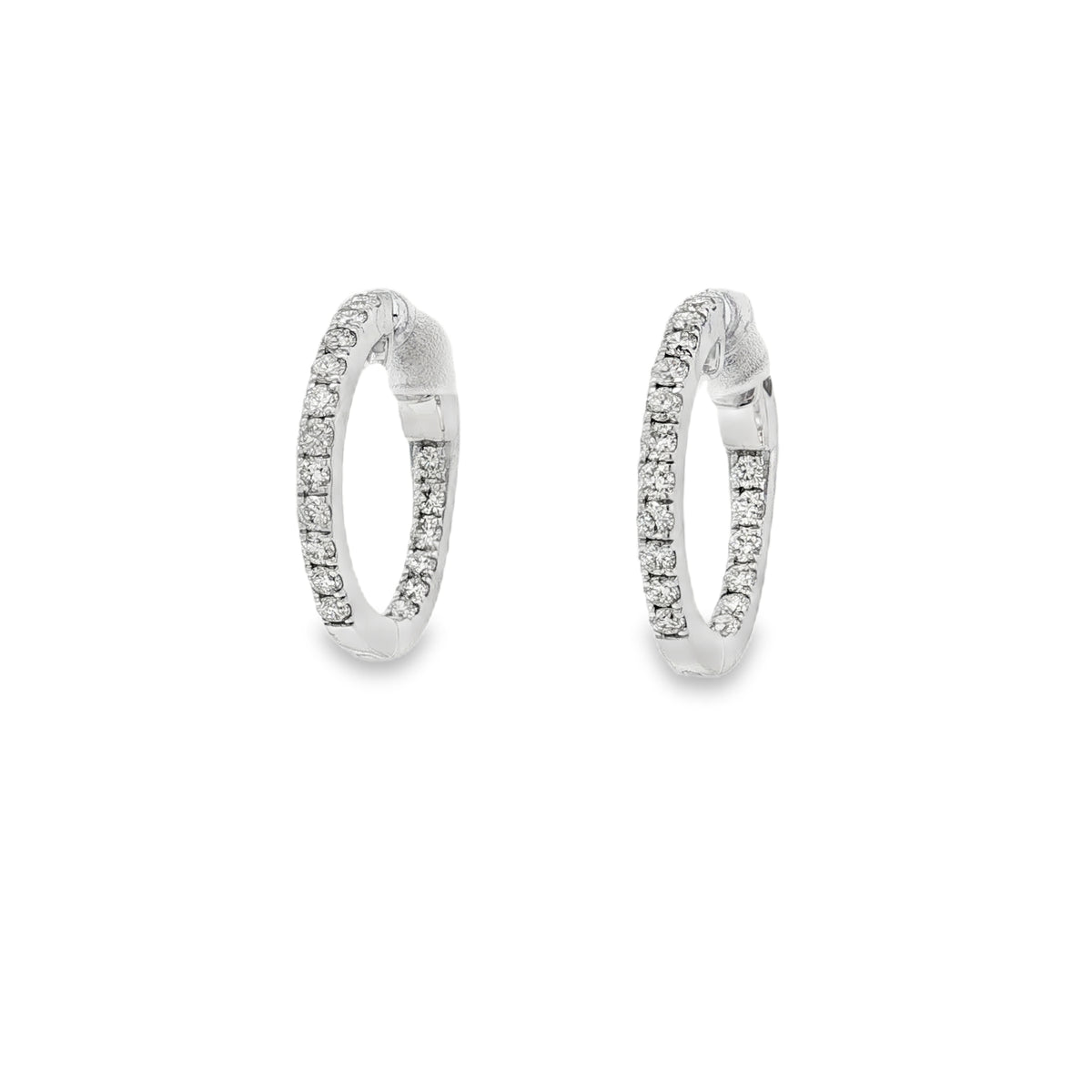 White gold hoop earrings with round diamonds along front and inner curves