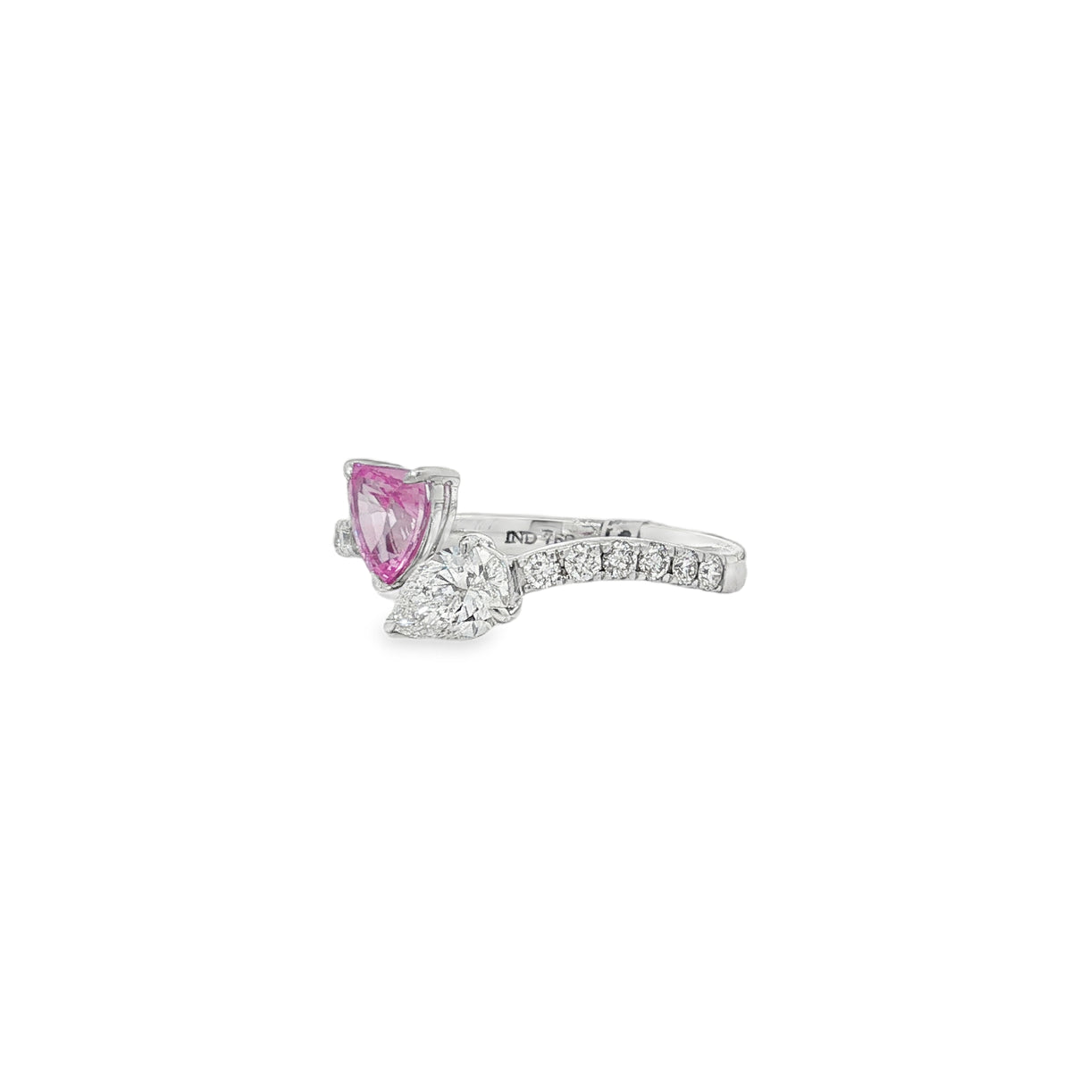 Side view of pink sapphire and pear diamond ring showing raised settings