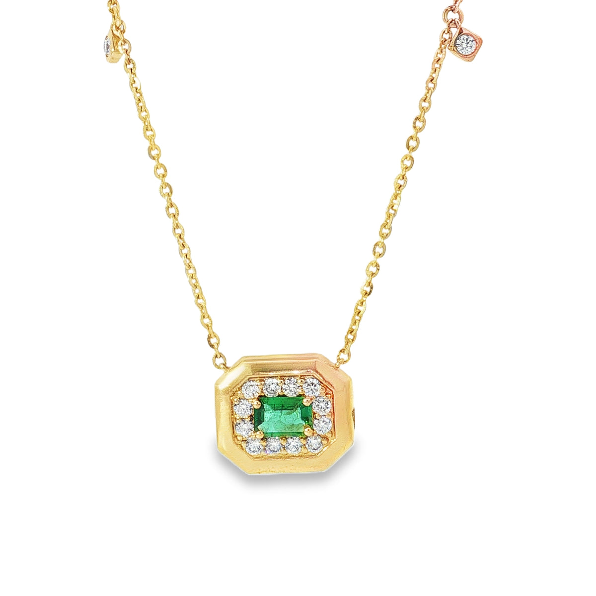 Yellow gold necklace with emerald, octagonal diamond halo centrepiece and chain accents
