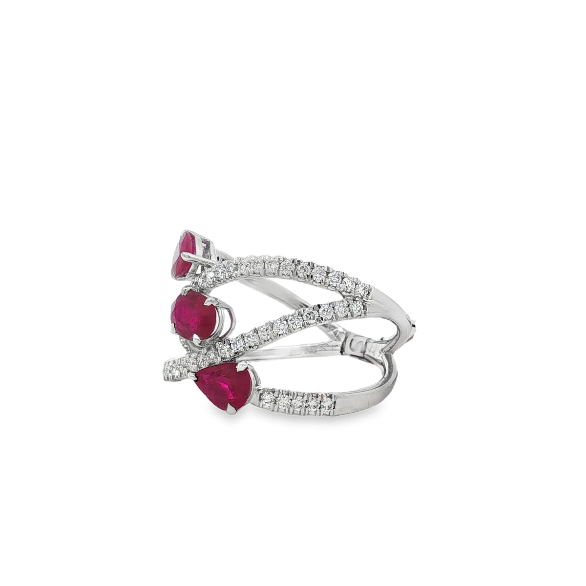 Angled view of ruby trio ring showing spaced diamond curves and raised settings