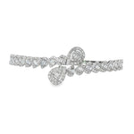 White gold diamond crossover bangle with baguette-filled teardrops and repeating angled motifs