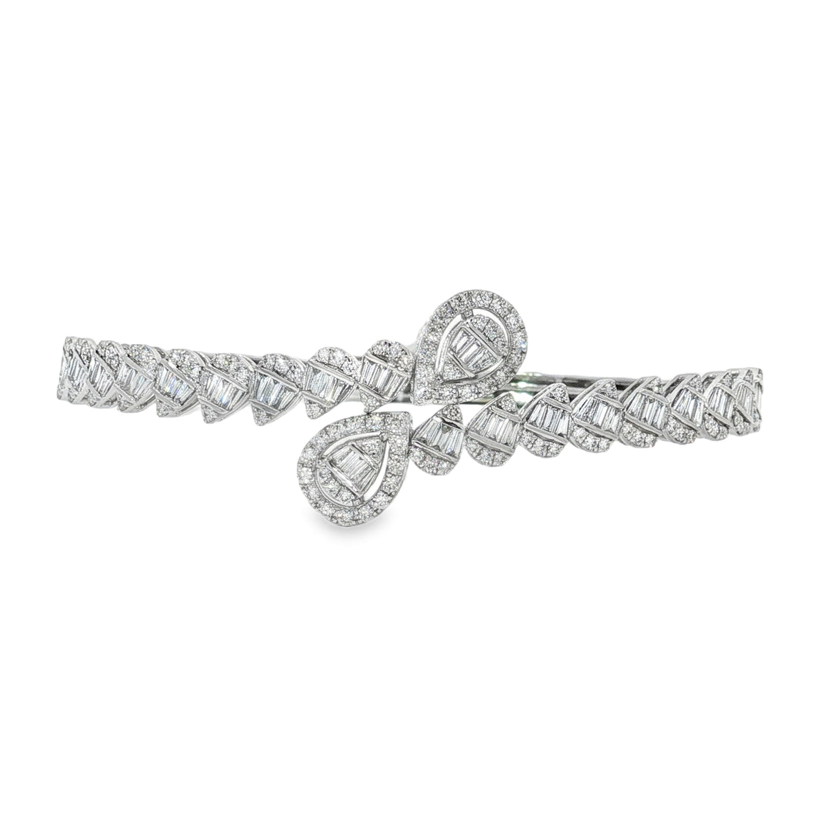 White gold diamond crossover bangle with baguette-filled teardrops and repeating angled motifs