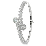 Side view of teardrop diamond crossover bangle showing its plain lower section