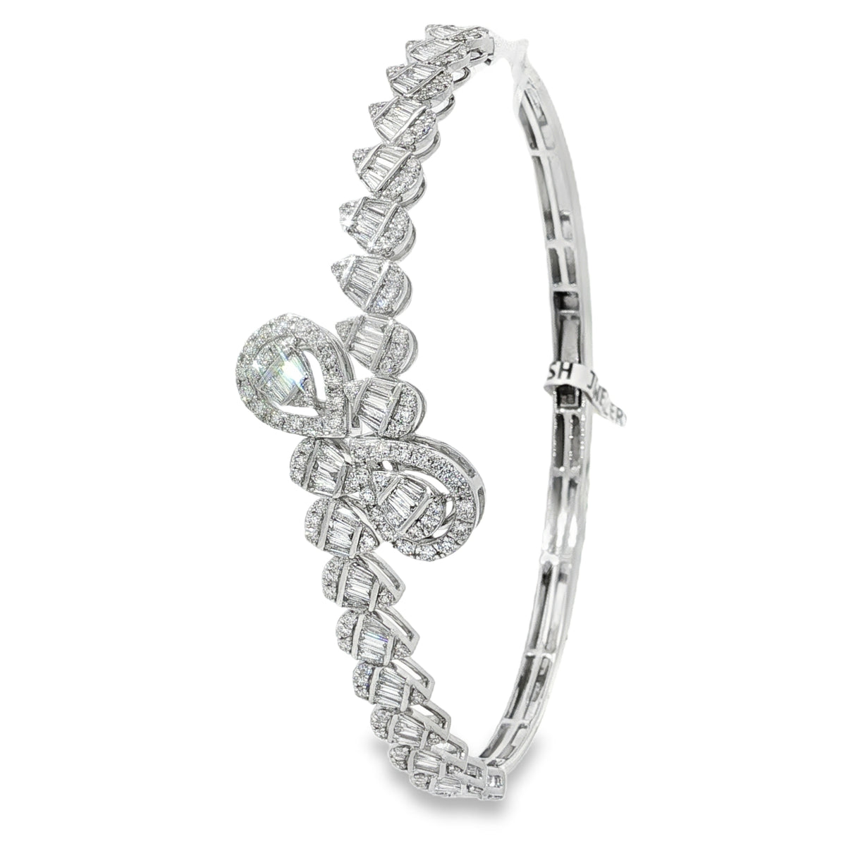 Side view of teardrop diamond crossover bangle showing its plain lower section