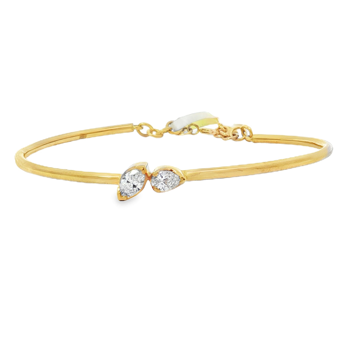 Yellow gold bangle with paired pear and marquise diamonds at the center
