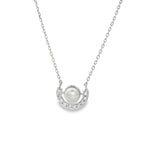 White gold necklace with single pearl in circular frame above a diamond crescent