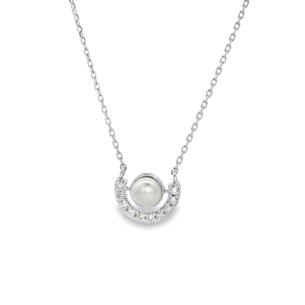 White gold necklace with single pearl in circular frame above a diamond crescent