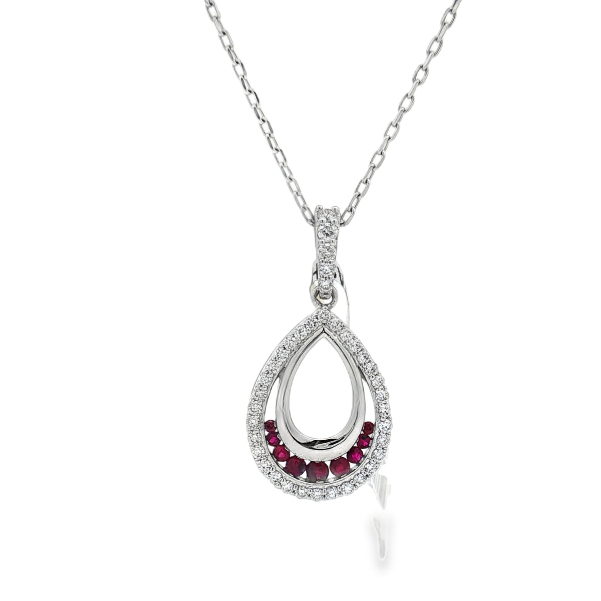 White gold open-teardrop pendant with ruby accents and a round diamond border