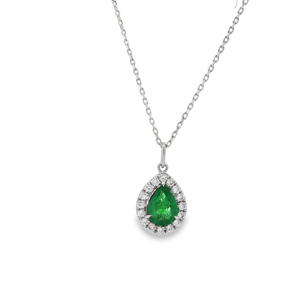 White gold necklace with a pear-shaped emerald surrounded by a round diamond halo