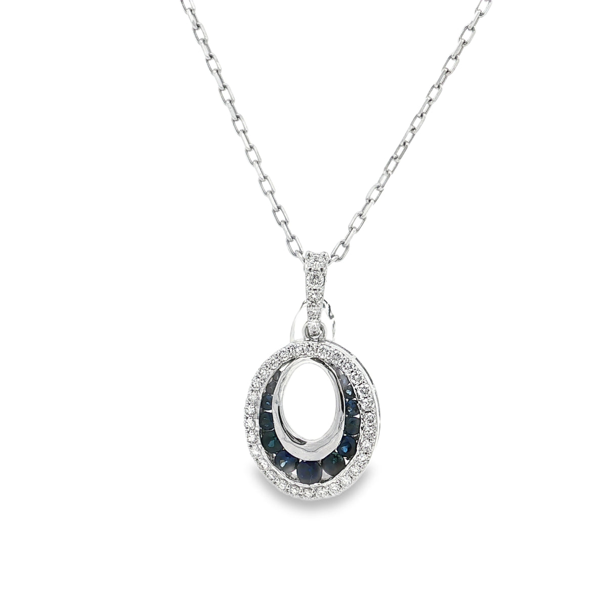 White gold open-oval pendant with lower sapphire accents and an outer diamond border