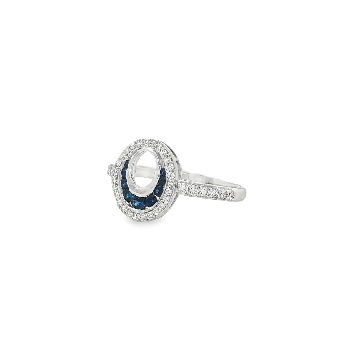 Angled view of open-oval sapphire ring showing diamond shoulders and raised frame