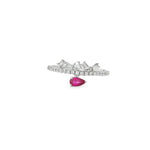 White gold ring with sideways pear ruby beneath a crown of angled baguette diamonds