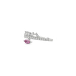 Angled view of oval pink sapphire ring showing diamond band and raised baguette crown