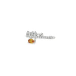 Angled view of oval orange sapphire ring showing diamond band and open crown settings