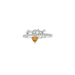 White gold ring with heart-shaped orange sapphire and a baguette diamond crown
