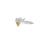 Angled view of orange sapphire heart ring showing the gemstone below the diamond band