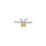 White gold ring with oval yellow sapphire beneath paired marquise diamond leaves